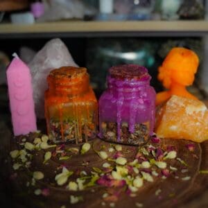 Orange and purple wax jars with petals